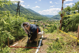 Male NPA deminer in Bosnia and Herzegovina conducting clearance while wearing aramid body armor and a polycarbonate visor. All images courtesy of Norwegian People’s Aid.