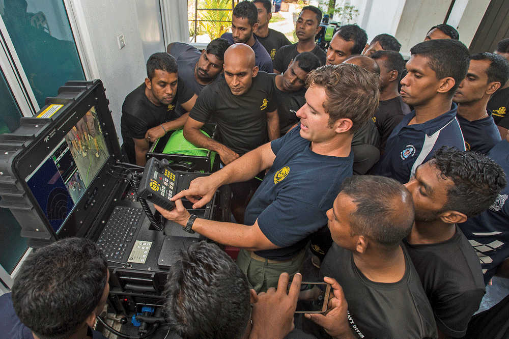 Figure 8. U.S. Navy EOD Mobile Unit 5 technician operating a remotely operated vehicle during humanitarian mine action operations with Sri Lanka Navy partners. Figure courtesy of United States Navy.23