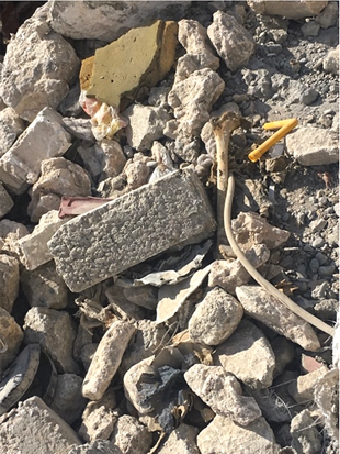 Figure 1. Disarticulated skeletonized human remains found within building rubble in Western Mosul, Iraq, 2017.  Image courtesy of Caroline Barker. 