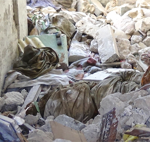 Figure 3. Human remains among the rubble in Al Maydan District, Iraq, 2017. Claimed to be an ISIL fighter, the remains were left untouched as HMA operations progressed around the deceased. A large amount of EO near the vicinity made access for clearance difficult and time consuming.  Figure courtesy of Gareth Collett.