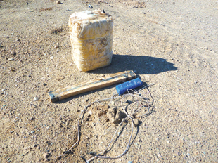 A typical Victim Operated IED in its constituent parts. The variety in potential layout of the components presents the operator with challenges that demand a different set of competencies to that of conventional EOD. Since 2018, T&EP 09.31 had detailed IEDD competency standards for mine action Image courtesy of Daniel Perkins.