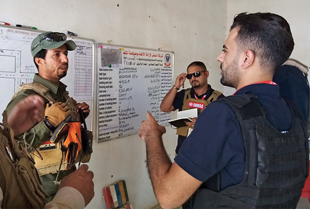 An NNGO team leader delivers a briefing at the start of a working day.