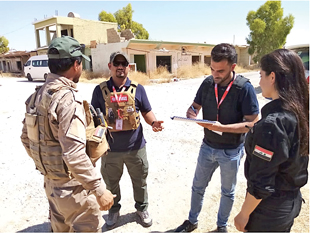 The end point? A national UNMAS Ops/QA officer speaks with a national clearance team leader and other staff during a clearance task.