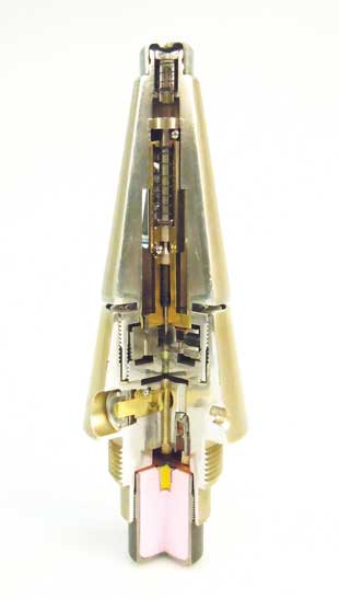 Figure 5 (left). An INERT MRV-U fuze complete. Note that the fuze appearance has been altered in order to make the item FFE. A full cut has been made above the shutter in order to gain access to the primers, stemming, and other energetic components. For some models, cuts on fuze bodies can be good initial indicators as to whether energetics have been removed and the item really is FFE. A window to view the setback sleeve has also been added during the inerting process. Making such an item FFE is an explosive process that should be conducted with a high level of risk management.  Figure courtesy of Dutch EOD Center.