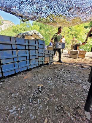 Albanian personnel inspect, audit, palletize, and store ammunition in accordance with international best practices.