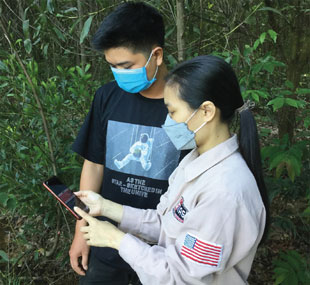 Sy and a MAG community liaison officer view the Facebook post that gave Sy the information on how to report the explosive ordnance he found on his land.
