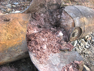 A German SC50 (fifty kg) aircraft bomb following a low-order procedure. Only a small amount of the explosive component was consumed by the deflagration. Image courtesy of Geir P. Novik.