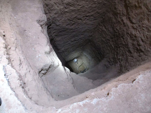 A nine-meter-deep excavation showing the tail of a bomb inside a house south of Mosul, Iraq.