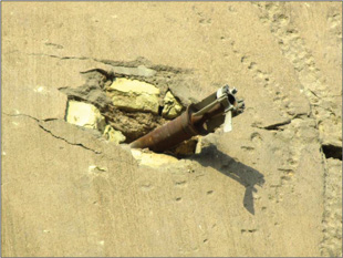 Image 7. Scene from the second story of a house in Fallujah, Iraq. A determination must be made if the munition is live or expended.