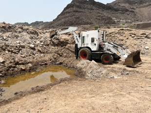 A Bobcat excavates a collapsed ammunition bunker in the heart of Aden city which exploded in 2015. Mechanical teams have cleared over 70 tons of EO across three collapsed ammunition bunkers, all of which HALO teams have destroyed. Image courtesy of The HALO Trust`.
