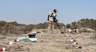 A HALO deminer sweeps a Minelab F3 detector on a minefield 4km north of Aden.  Image courtesy of The HALO Trust.
