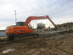 Armored excavator from FSD’s mechanical clearance team in Iraq removing rubble so that villagers can return to their land and rebuild their homes and livelihoods.  Image courtesy of FSD.