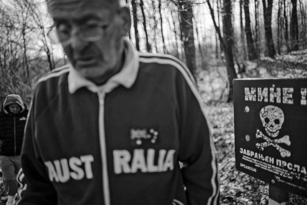 Enes Čandić walking near contaminated land.
