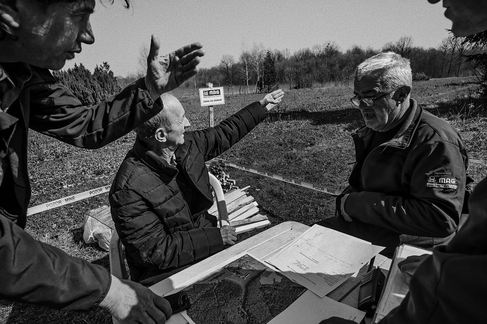 Želiko Jović works with the team to help identify landmarks found on old minefield sketch maps.