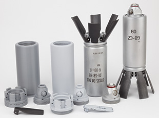 A variety of gray cylinders standing on end, some with fins.