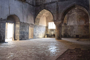 The empty, stone interior of a Mosque.