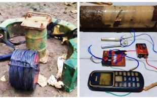 Improvised explosive device components such as metal pieces, wire, and a phone.