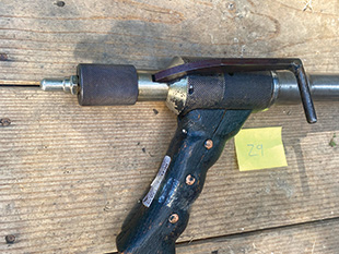 A homemade firearm with a grip and a steel barrel.