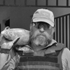 Headshot of Drew A. Prater wearing sunglasses and a baseball hat.