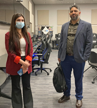 Two people stand in a college lab.