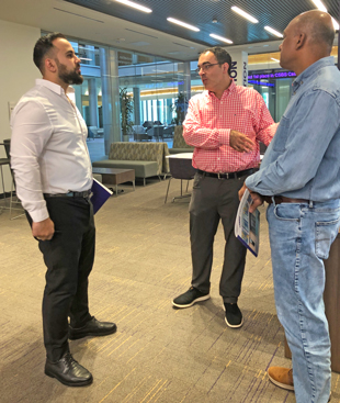 Omed Zawity and Farris Moussa talk in the JMU College of Business building.