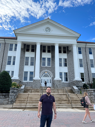OGM Director Omed Zawity stands in front of Wilson Hall at JMU.