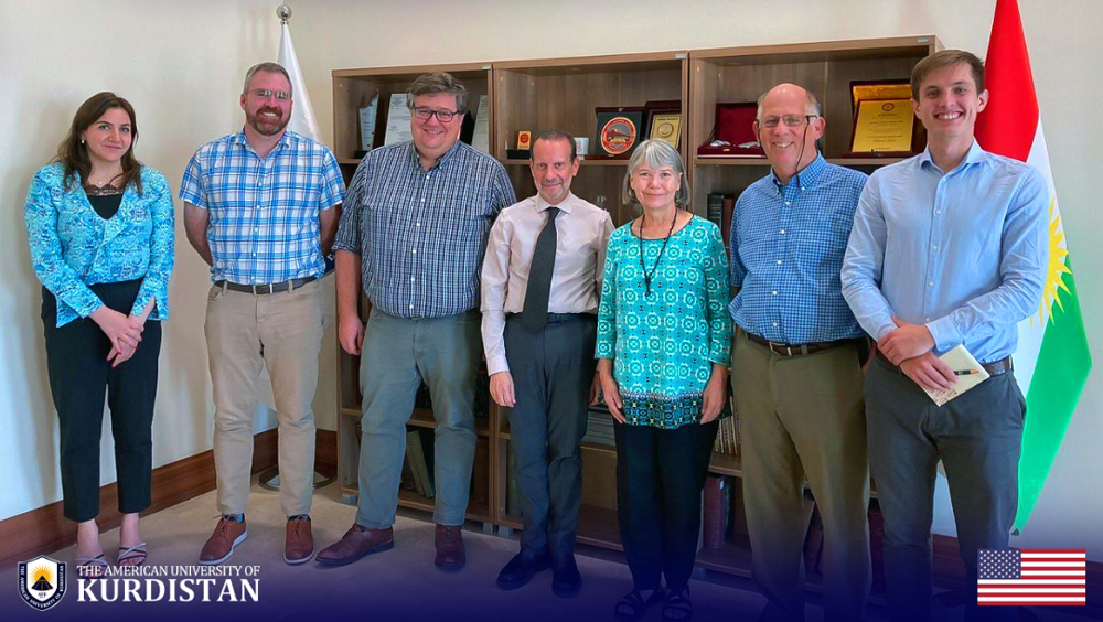 CISR staff, JMU faculty, and AUK staff pose together in a room during a visit to AUK.