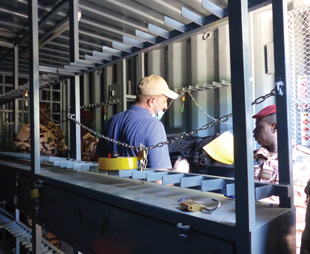 people in a building with metal shelves