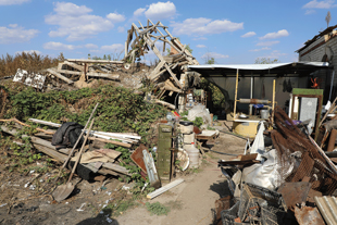 A pile of debris next to a building destroyed by fighting in Ukraine.