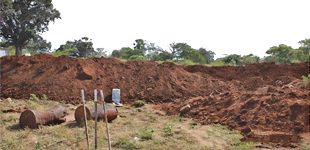 a pile of dirt excavated from the ground as part of a construction process