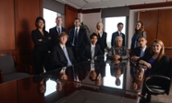 Group of JMU MSA students, in business attire, posed around a conference table