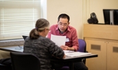 A CoB student helps a community member with their taxes during VITA