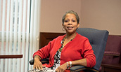 Daphyne Thomas sitting in a chair in her office