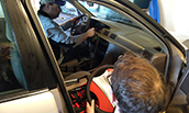 John Kruggel and Benjamin Hamilton work on the project car donated to a local family