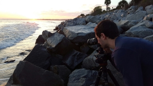 Garrett Martin composing a coastal shot with his tripod