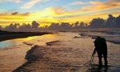 Garrett Martin, '16, composing a sunset shot on a beach