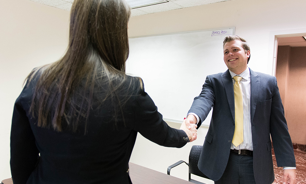 Student shaking hands with a judge during Internal Sales Competition - 2017