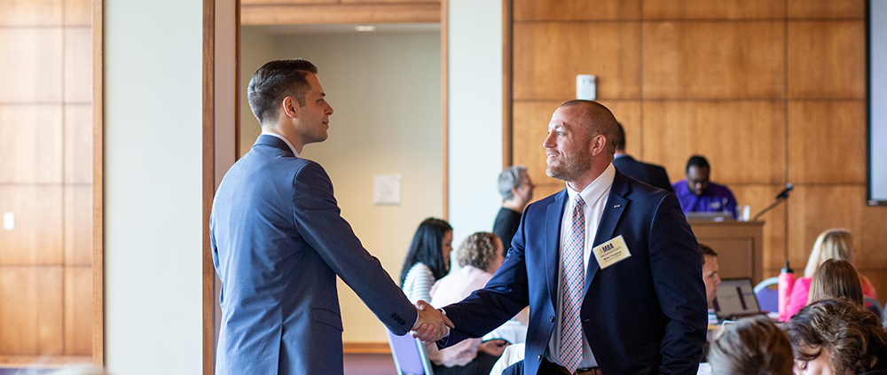 A JMU MBA students connects with an instructor during orientation