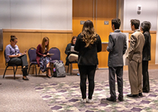 Four high school student present their business idea to a group of judges in the Festival Ballroom. 