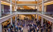 The Madison Singers, under the direction of Jo-Anne van der Vat-Chromy,  provide a musical interlude in the ceremony from Hartman Hall’s second-floor Thompson mezzanine.