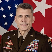 Portrait of a U.S. Army general in uniform standing in front of U.S. and Army flags.