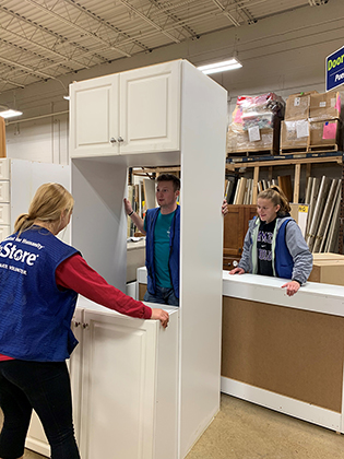 Students assembling cabinets during alternative Spring Break - 2019