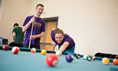 Two JMU students enjoying a game of pool