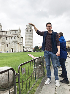 CIS student posing humorously with the leaning tower of Pisa - 2019