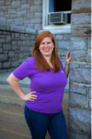 picture of Katie Lese, tutor alum, standing next to building