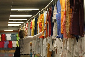 photo of woman looking at t-shirts