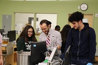 photo of professor working with students in lab