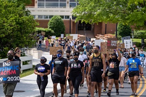 students and community members marching across campus 