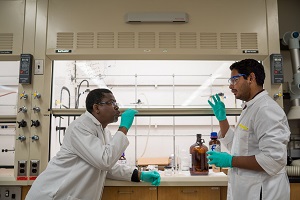 photo of two chemists signing in lab