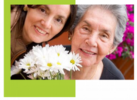 photo of two women holding daisies